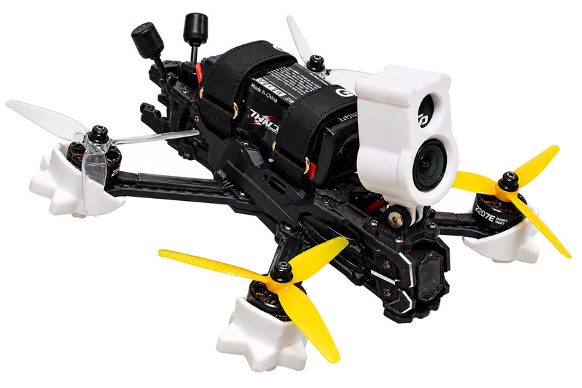 A 5-inch freestyle quad, battery strapped on, with an action camera held over the stack in a printed cradle.